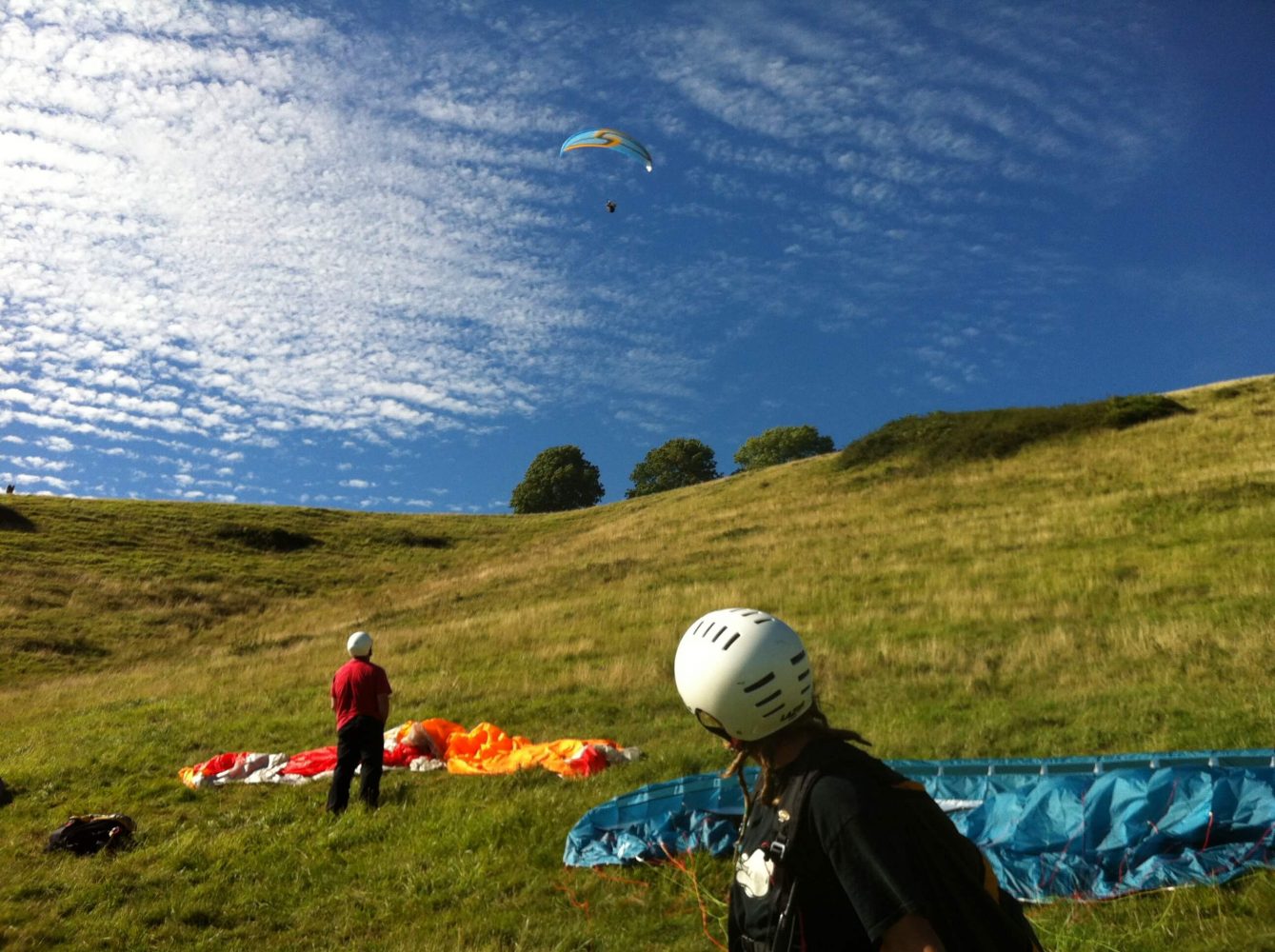 Paragliders on the countryside hill
