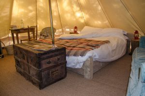 A bed inside of a yurt