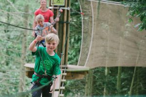 Children playing on tightrope at Go Ape