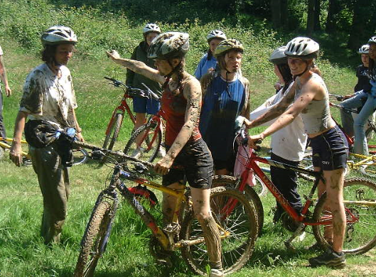 A group of muddy cyclists