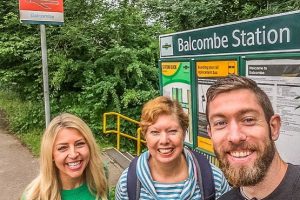 Luke and family in front of Balcombe Station sign