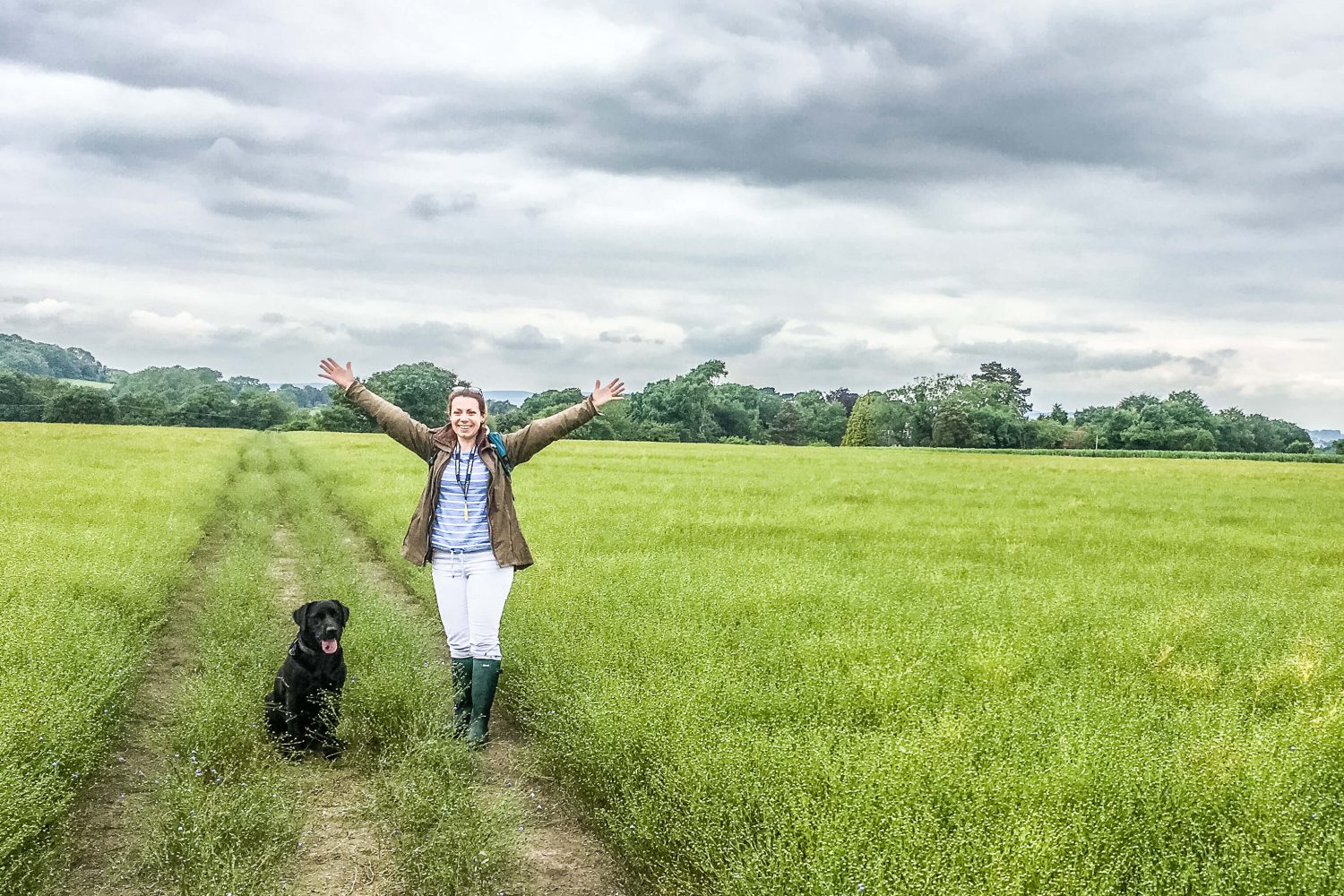 Woman and dog in field