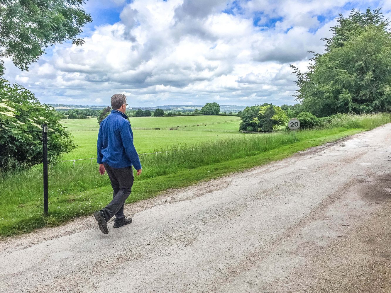 Man walking down countryside lane