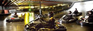 A group of go kart racers on an indoors track