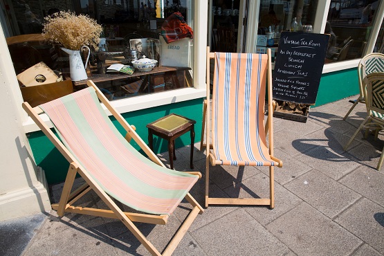 Two deck chairs outside a cafe