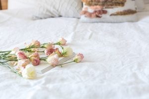 Old House Inn white bed spread with pastel flowers