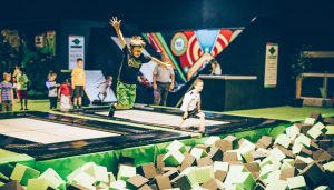 Flip out indoor trampoline park with children jumping into foam pit