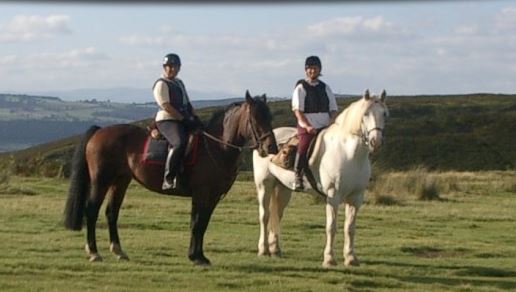 Two horse riders in the countryside