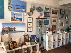 The interior of Shoreham Art Gallery showing pictures, crafts and objects