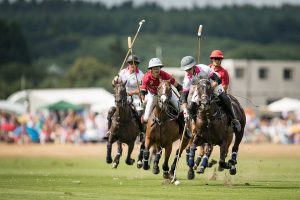 Four polo players on horses at Cowdray Park Polo
