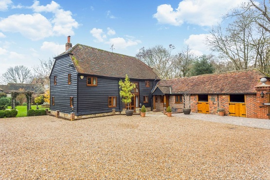 A renovated cladded barn and outbuildings in Sussex providing luxury accommodation for famileis and groups
