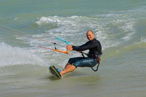 Lewis Crathern kitesurfing on the water in Sussex