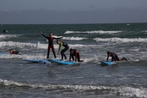 Children learning to surf in West Sussex