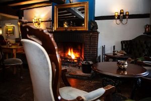 Cosy fire in the lounge area of the The Queens Head in West Chiltington