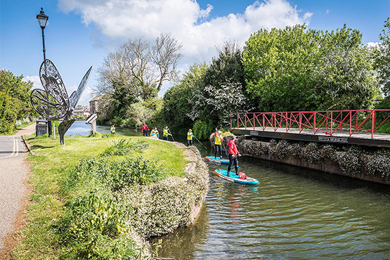 A group paddleboarding on the the river in Chichester