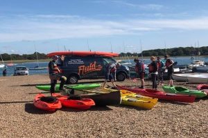 A group ready for a kayaking lesson with Fluid Adventures in West Sussex