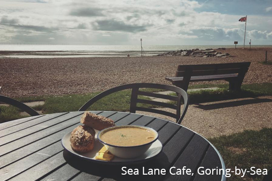 Soup and a roll on an outside table with views of the West Sussex coast.