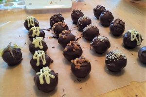 Rows of handmade chocolate truffles made at the Artisan Bakehouse