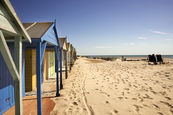 Beach huts on a beautiful sandy beach on the South of England