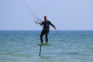 Kitesurfer in the water mid jump
