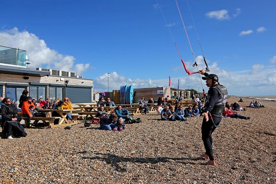 A kitesurfing instructor demonstrating to a crowd on Littlehampton beach